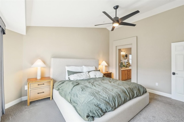 bedroom featuring connected bathroom, baseboards, and light colored carpet