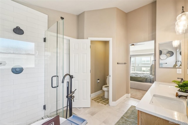 ensuite bathroom featuring a sink, toilet, and a stall shower