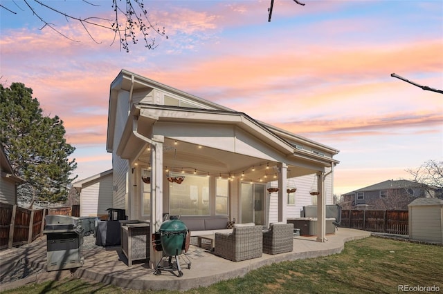 rear view of house featuring a yard, an outdoor hangout area, fence private yard, and a patio