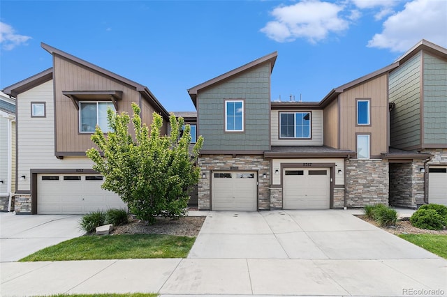 9757 Ash Ln, Thornton, CO 80229 - view of front facade with stone siding, an attached garage, and concrete driveway