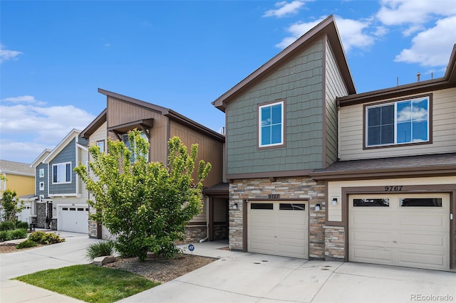 9757 Ash Ln, Thornton, CO 80229 - view of front of home with stone siding, an attached garage, and driveway