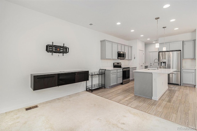 9757 Ash Ln, Thornton, CO 80229 - kitchen with stainless steel appliances, a sink, gray cabinetry, recessed lighting, and light countertops