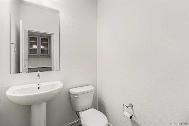 9757 Ash Ln, Thornton, CO 80229 - half bathroom with toilet and a sink