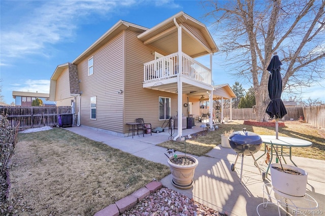 back of house featuring a balcony, a yard, ceiling fan, and a patio area