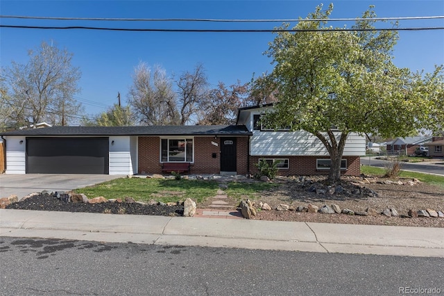6013 W 62nd Ave, Arvada, CO 80033 - tri-level home featuring an attached garage, concrete driveway, and brick siding