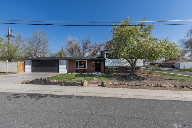 6013 W 62nd Ave, Arvada, CO 80033 - view of front of property featuring an attached garage, concrete driveway, and brick siding