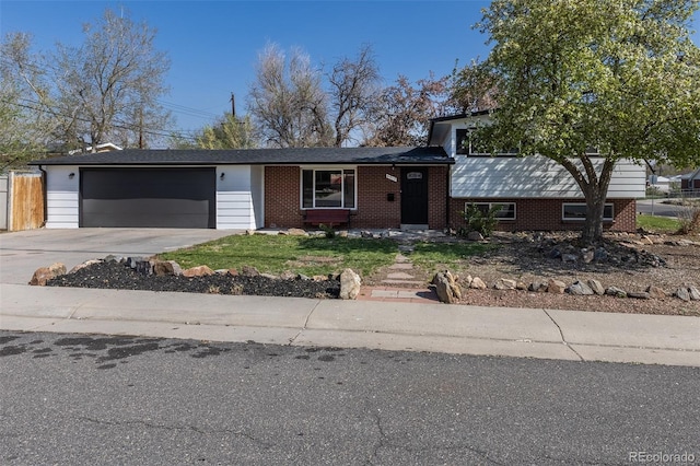 6013 W 62nd Ave, Arvada, CO 80033 - tri-level home with an attached garage, driveway, and brick siding
