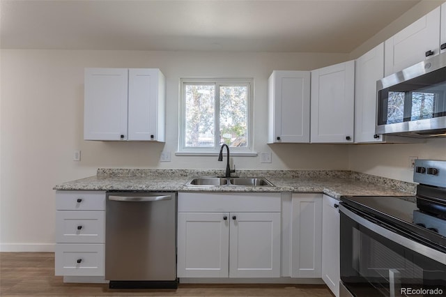 6013 W 62nd Ave, Arvada, CO 80033 - kitchen with stainless steel appliances, a sink, and white cabinets