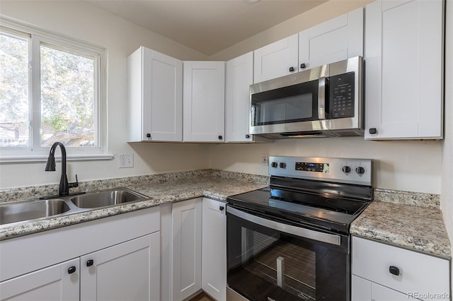 6013 W 62nd Ave, Arvada, CO 80033 - kitchen with stainless steel appliances, a sink, light countertops, and white cabinets