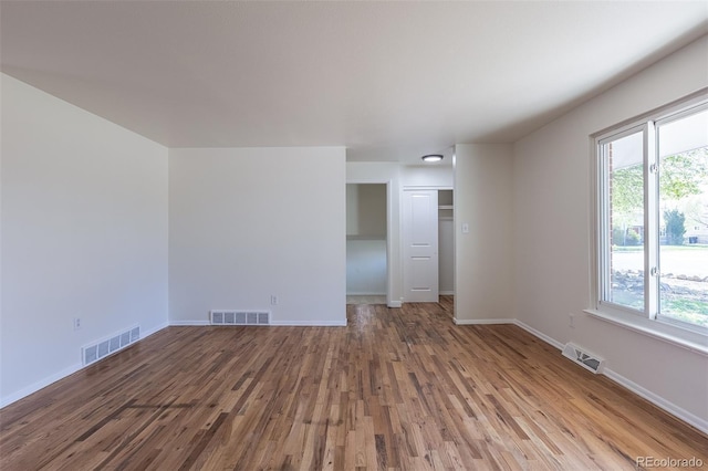 6013 W 62nd Ave, Arvada, CO 80033 - empty room featuring wood finished floors, baseboards, and plenty of natural light