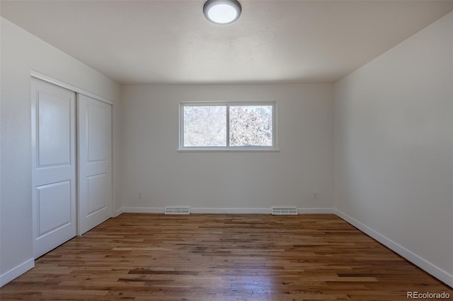 6013 W 62nd Ave, Arvada, CO 80033 - unfurnished bedroom featuring wood finished floors, a closet, and baseboards