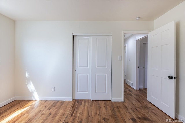 6013 W 62nd Ave, Arvada, CO 80033 - unfurnished bedroom featuring wood finished floors, a closet, and baseboards