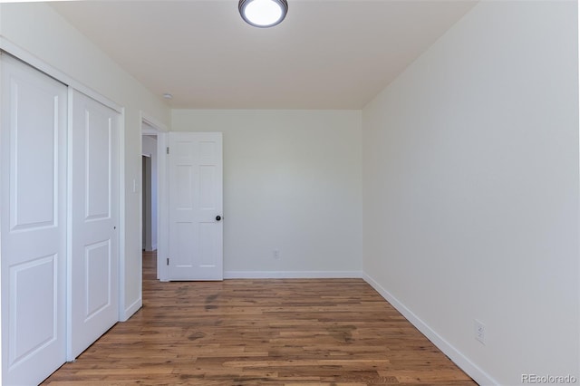 6013 W 62nd Ave, Arvada, CO 80033 - unfurnished bedroom featuring wood finished floors, baseboards, and a closet
