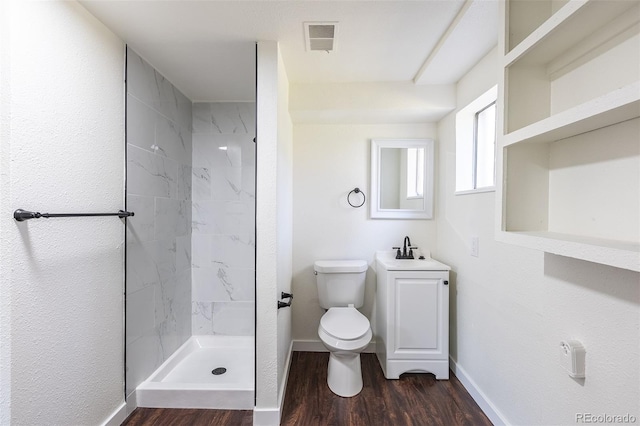 6013 W 62nd Ave, Arvada, CO 80033 - full bathroom featuring toilet, baseboards, a shower, and wood finished floors