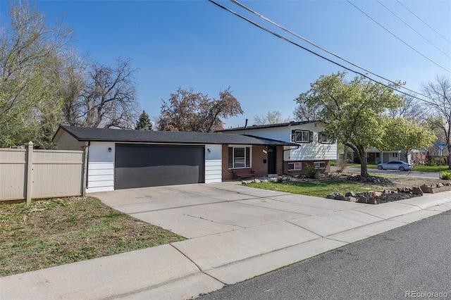 6013 W 62nd Ave, Arvada, CO 80033 - tri-level home with a garage, concrete driveway, and brick siding