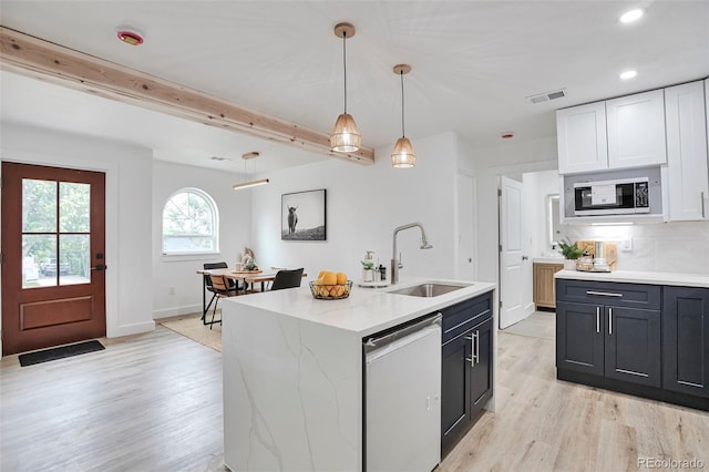 1360 W Custer Pl, Denver, CO 80223 - kitchen with dishwasher, light wood-type flooring, recessed lighting, decorative light fixtures, and an island with sink