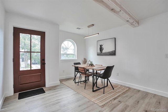 1360 W Custer Pl, Denver, CO 80223 - dining area featuring light wood-type flooring and beamed ceiling