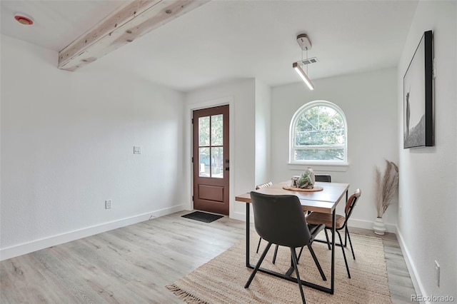 1360 W Custer Pl, Denver, CO 80223 - dining area featuring light wood finished floors and beam ceiling