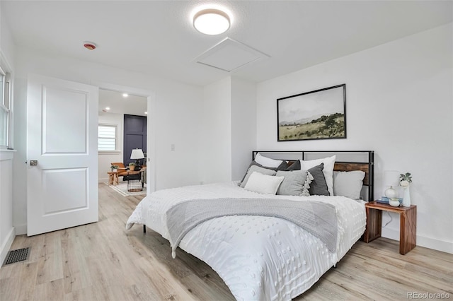 1360 W Custer Pl, Denver, CO 80223 - bedroom with attic access, light wood-style flooring, and a desk