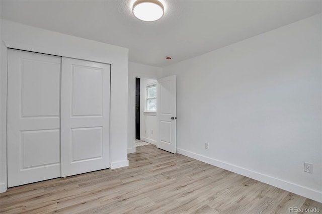 1360 W Custer Pl, Denver, CO 80223 - unfurnished bedroom featuring light wood finished floors and a closet