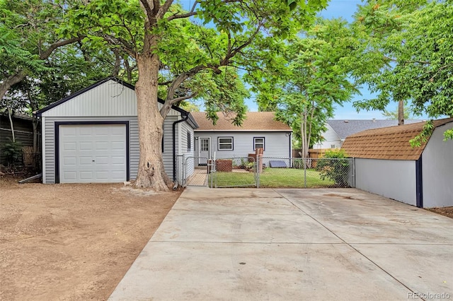 1360 W Custer Pl, Denver, CO 80223 - view of front facade with a gate, a storage unit, and driveway