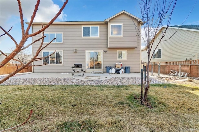 back of house with a lawn and a patio