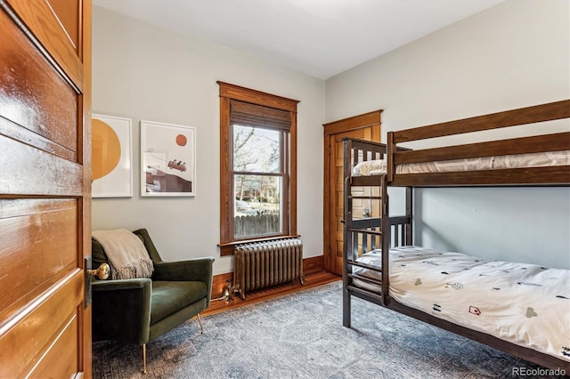 bedroom featuring radiator and light hardwood / wood-style flooring