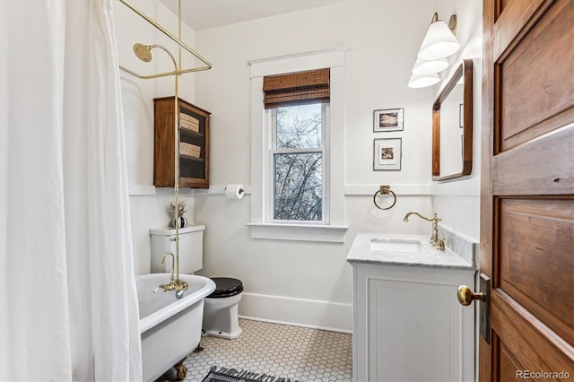 bathroom with vanity, tile patterned flooring, and toilet