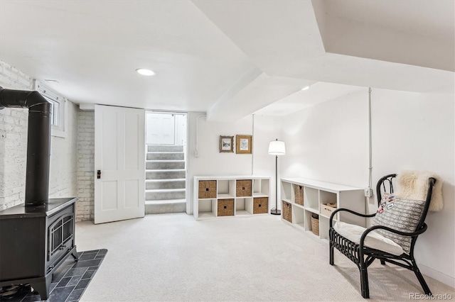 living area with a wood stove and dark carpet