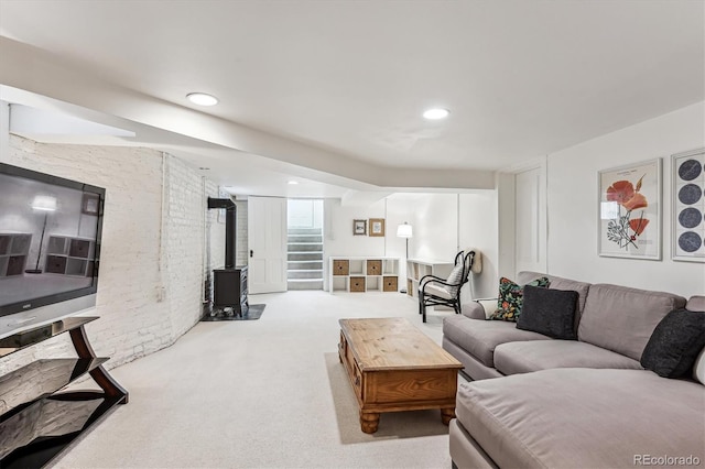 living room with a wood stove and light colored carpet