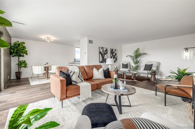 living area with wood finished floors and visible vents