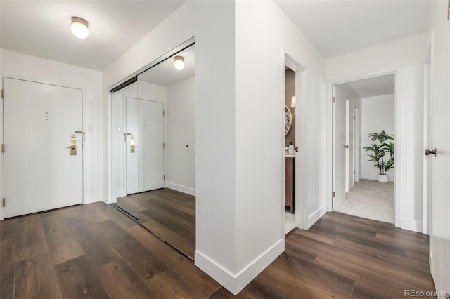 foyer entrance featuring wood finished floors and baseboards