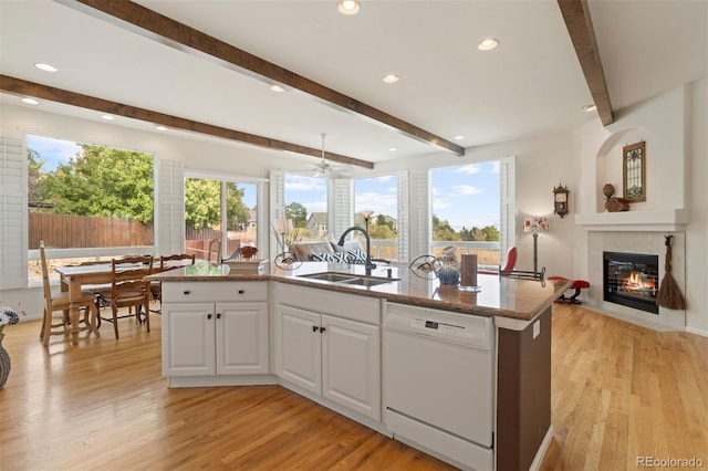 kitchen featuring a center island with sink, dishwasher, white cabinetry, and sink