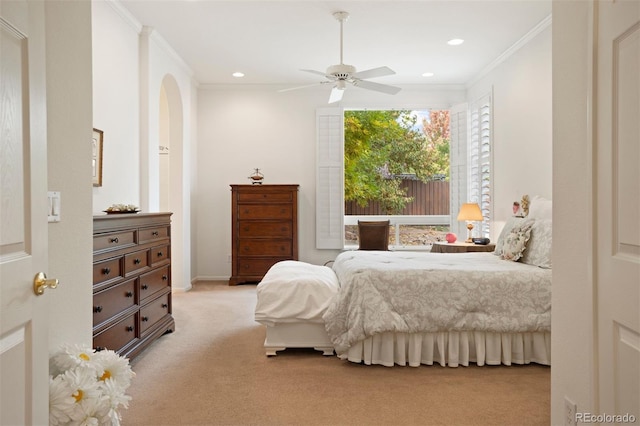 carpeted bedroom featuring ceiling fan and ornamental molding