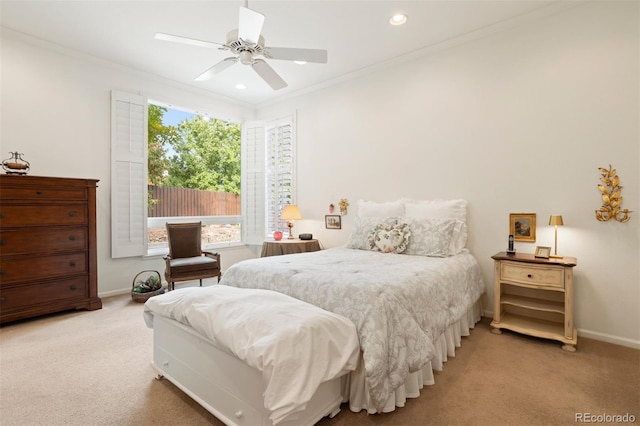 carpeted bedroom with ceiling fan and crown molding