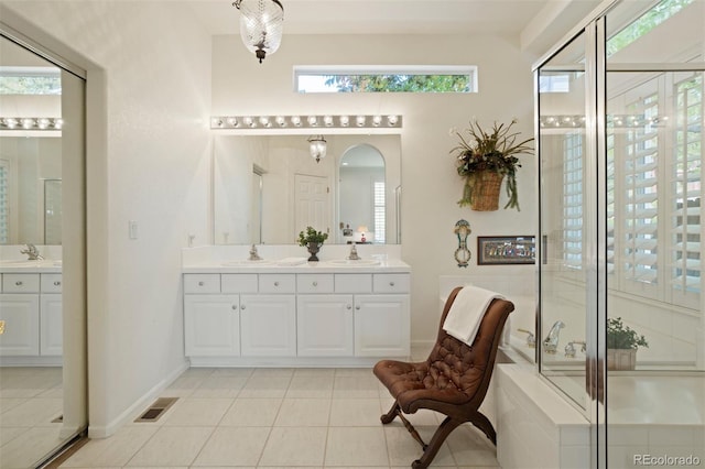 bathroom featuring tile patterned floors, vanity, and walk in shower