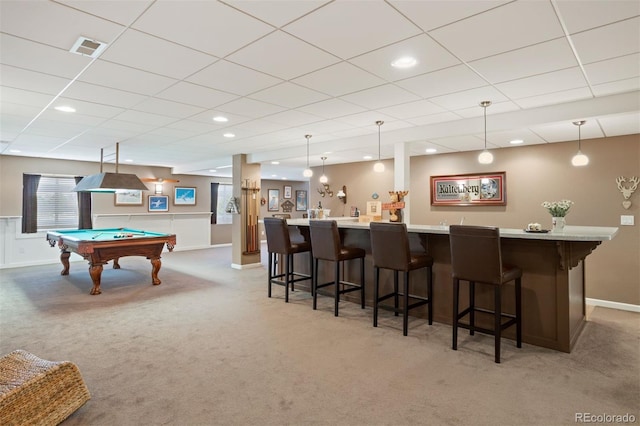 rec room featuring a paneled ceiling, carpet floors, pool table, and bar area