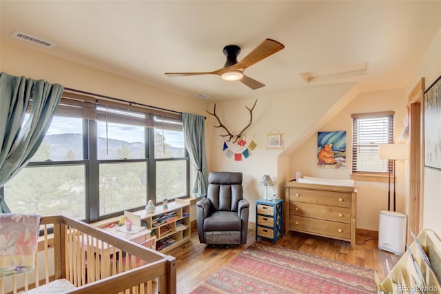 30490 Harvard Cir, Buena Vista, CO 81211 - bedroom with hardwood / wood-style floors, multiple windows, and a crib