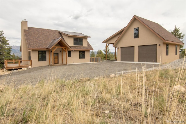 30490 Harvard Cir, Buena Vista, CO 81211 - traditional home with a garage, stucco siding, a deck, and a chimney