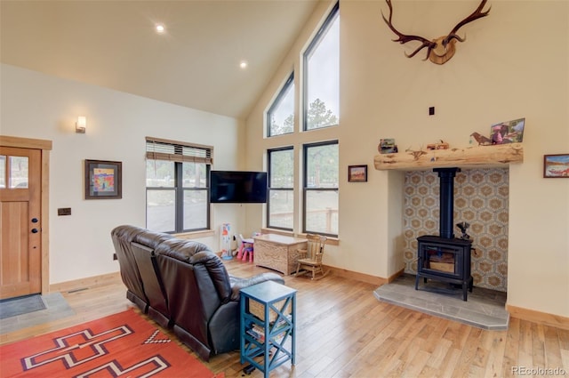 30490 Harvard Cir, Buena Vista, CO 81211 - living room featuring wood finished floors, high vaulted ceiling, a wood stove, baseboards, and recessed lighting