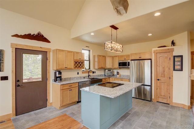 30490 Harvard Cir, Buena Vista, CO 81211 - kitchen with appliances with stainless steel finishes, light brown cabinetry, a sink, healthy amount of natural light, and vaulted ceiling