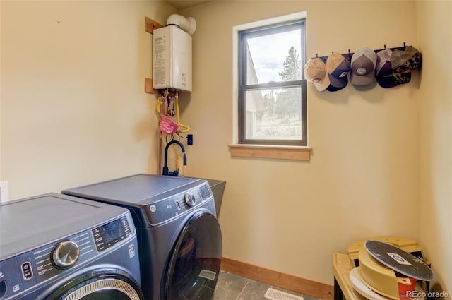 30490 Harvard Cir, Buena Vista, CO 81211 - washroom with independent washer and dryer, water heater, baseboards, and tile patterned floors