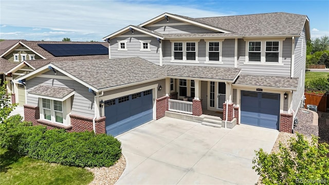 5932 Eldora St, Golden, CO 80403 - craftsman house with brick siding, a porch, driveway, and roof with shingles