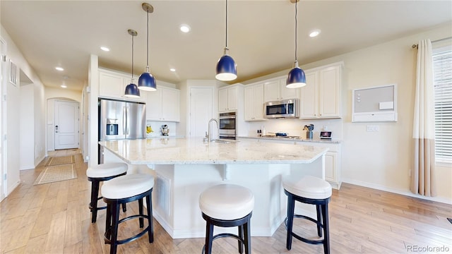 5932 Eldora St, Golden, CO 80403 - kitchen with stainless steel appliances, light wood-type flooring, white cabinets, and recessed lighting