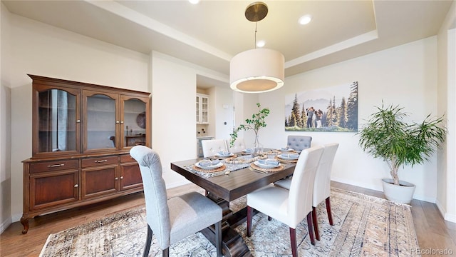 5932 Eldora St, Golden, CO 80403 - dining area featuring light wood-style flooring, baseboards, a raised ceiling, and recessed lighting