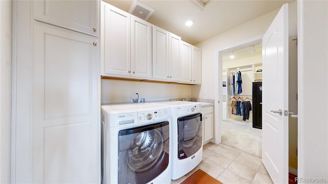 5932 Eldora St, Golden, CO 80403 - laundry room featuring washer and clothes dryer, cabinet space, light tile patterned floors, recessed lighting, and light colored carpet