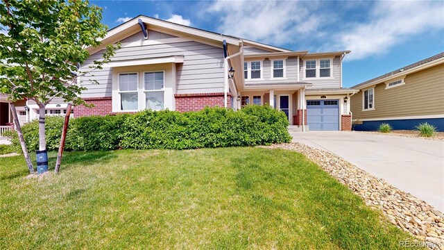 5932 Eldora St, Golden, CO 80403 - view of front of home with brick siding, driveway, a front lawn, and a garage
