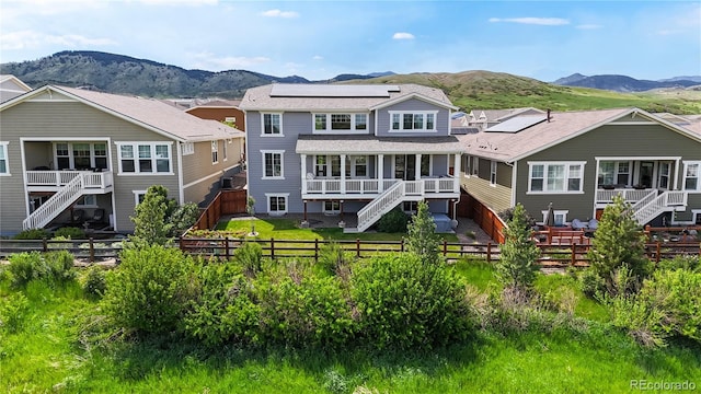 5932 Eldora St, Golden, CO 80403 - rear view of house with a mountain view, a fenced backyard, solar panels, and stairway