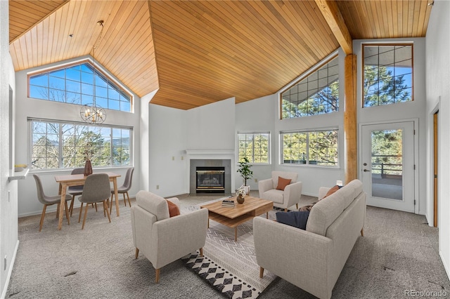 carpeted living area with wood ceiling, a fireplace, high vaulted ceiling, and baseboards