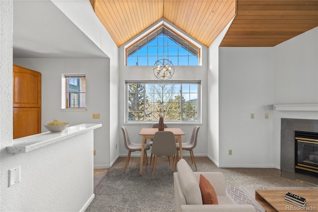 dining room with carpet floors, wood ceiling, baseboards, and vaulted ceiling